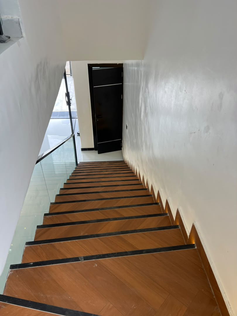 Staircase with wooden treads and glass balustrade