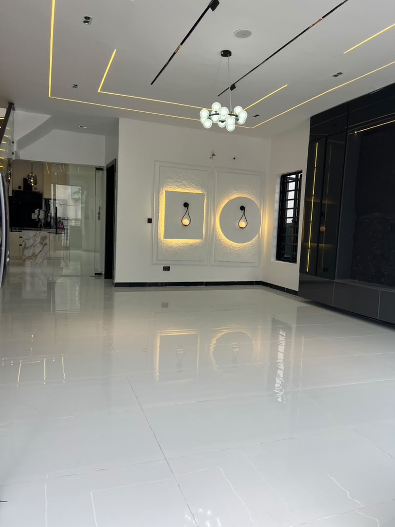 Open plan living and dining space with feature lighting