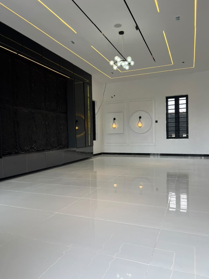 Living area with recessed lighting and feature TV wall